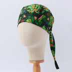 TMNT scrub cap with colorful pizza and turtle graphics shown in side profile view on mannequin head