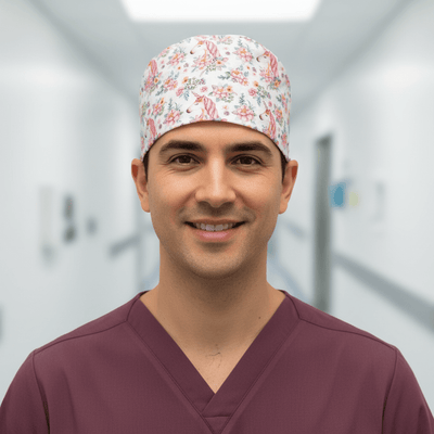 White scrub cap with pink unicorn and floral pattern for medical professionals