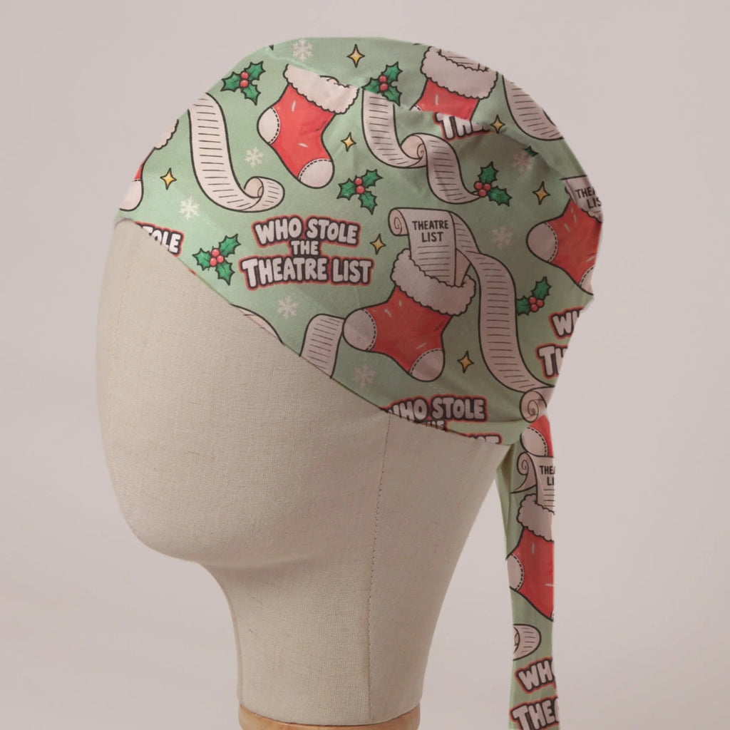Who Stole The Theatre List scrub cap: Christmas stockings stuffed with long theatre lists and holly on sage green