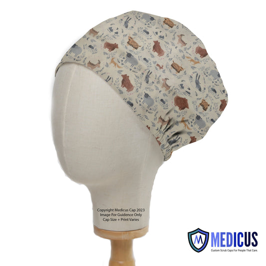 A mannequin head wears a Medicus Scrub Caps Boho Boheme Animals Scrub Cap, featuring a beige fabric with illustrated animals, ideal for healthcare professionals.