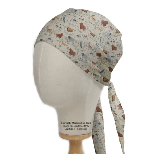 The Boho Boheme Animals Scrub Cap by Medicus Scrub Caps features a wildlife pattern with adjustable ties, displayed on a mannequin head. Size and print may vary.