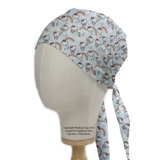 A mannequin displays the Medicus Scrub Caps Hello Kitty Scrub Cap, featuring a light blue fabric with Hello Kitty, rainbows, and stars, tied neatly at the back.