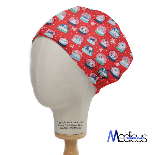 A mannequin head displays the Christmas Snow Globes Red Scrub Cap by Medicus Scrub Caps, featuring festive snow globe patterns on a vibrant red background.