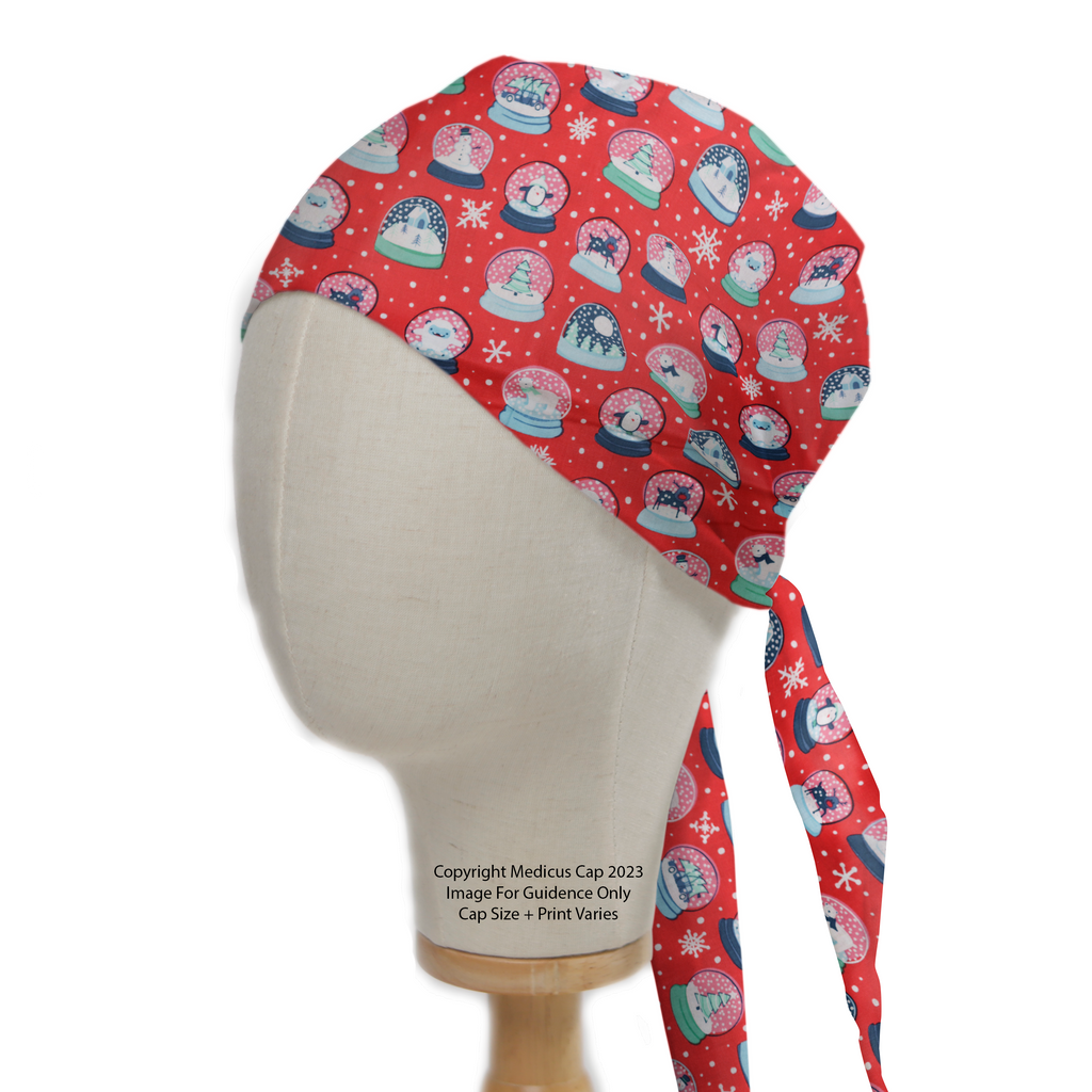 Festive Medicus Scrub Caps Christmas Snow Globes Red Scrub Cap on a mannequin, featuring snowmen and snowflakes in snow globes. Tie-back design for comfort.
