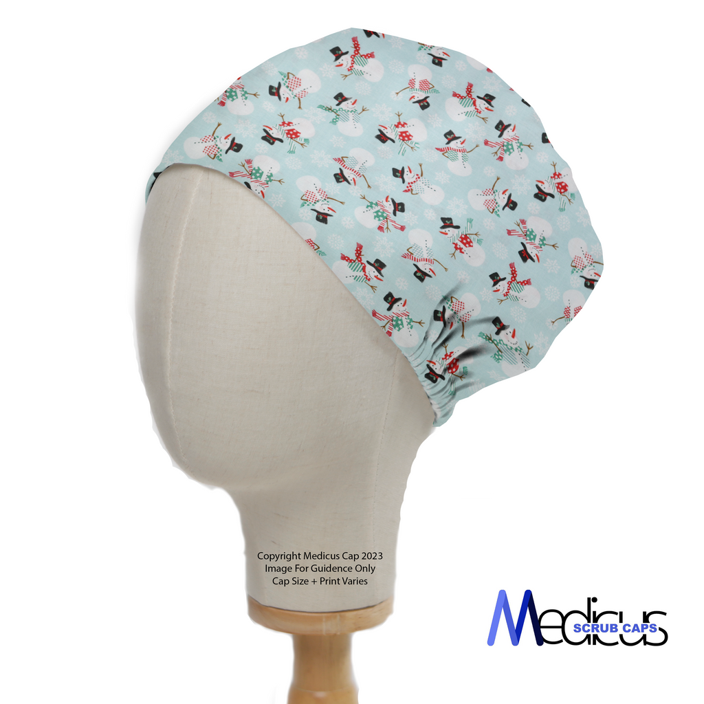 A mannequin head displays the Christmas Snowmen Scrub Cap, featuring festive snowmen on a light blue background. Medicus Scrub Caps branding is in the bottom right corner.