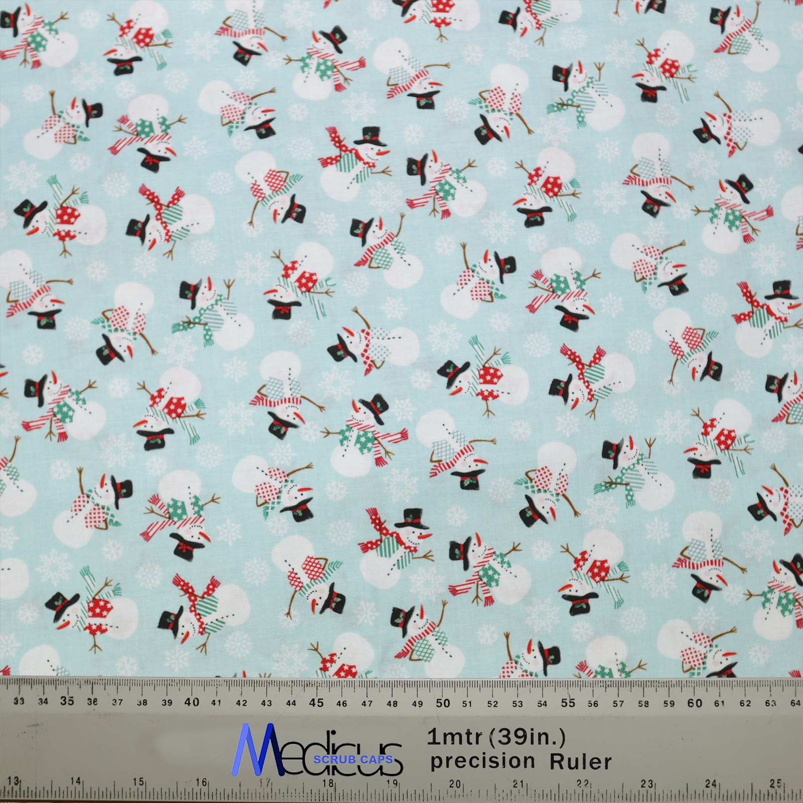 The Christmas Snowmen Scrub Cap by Medicus Scrub Caps features a festive pattern of snowmen in hats and scarves on a light blue background.