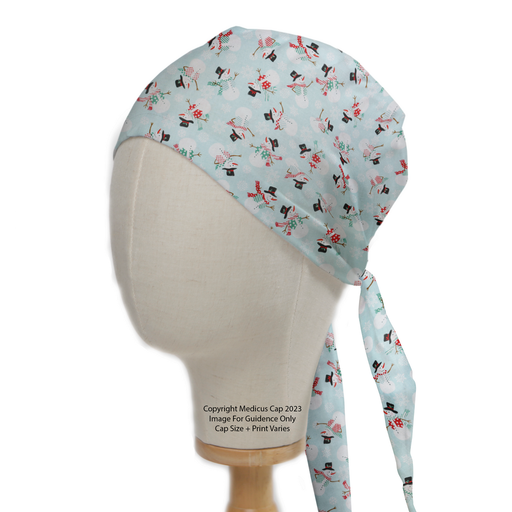 The Christmas Snowmen Scrub Cap by Medicus Scrub Caps features a festive light blue design with snowmen and ties at the back, perfect for the holidays.