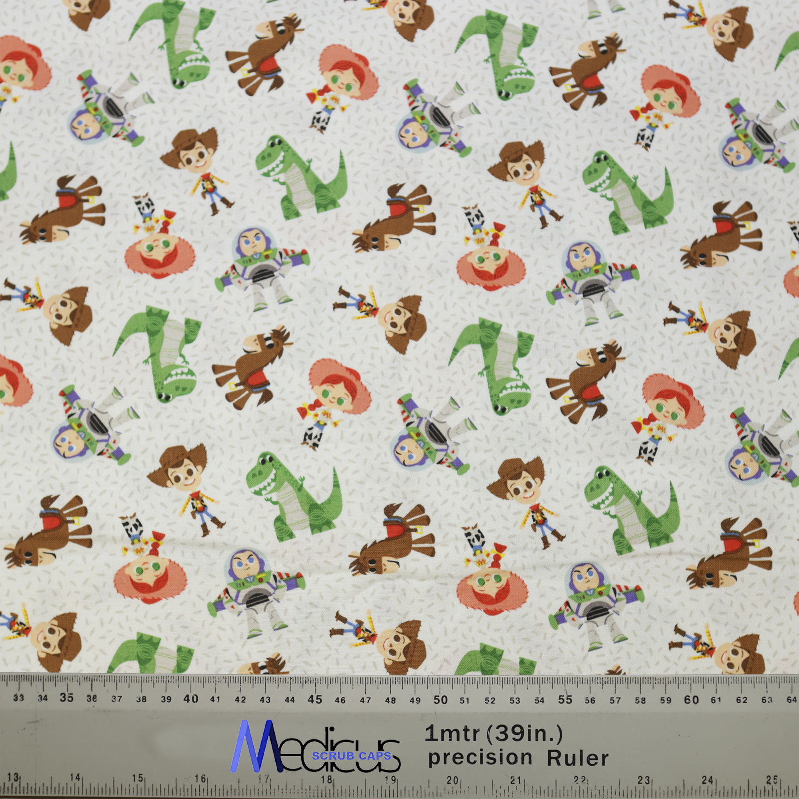Medicus Scrub Caps fabric featuring a Disney Pixar Toy Story 2 character mashup with Woody, Buzz, Jessie, and more on a white background.