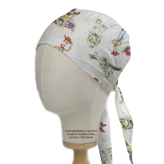 A mannequin displays a Medicus Scrub Caps Disney Pixar Toy Story Buzz Woody Flying White Scrub Cap, featuring colorful characters, star patterns, and tie-back closure.