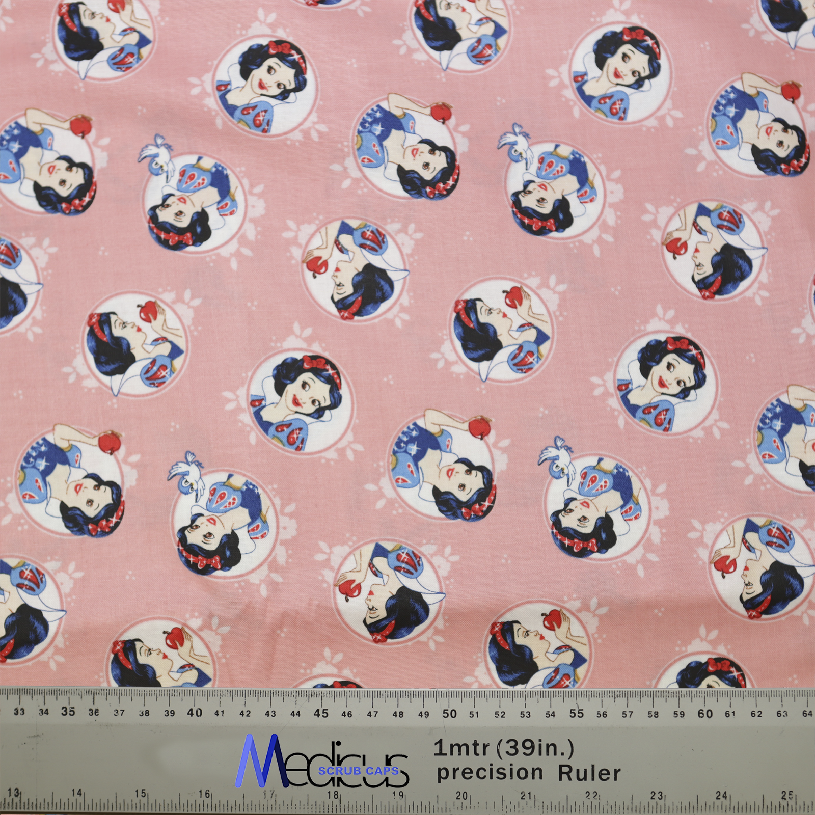 Disney Princess Snow White on Pink Scrub Cap fabric from Medicus Scrub Caps, featuring Snow White in various poses on a soft pink background.