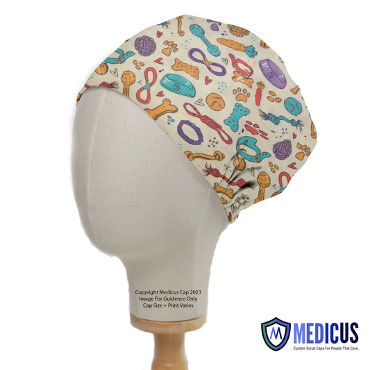 Dogs Accessories Collars Scrub Cap from Medicus Scrub Caps, featuring a playful dog-themed pattern with paw prints, bones, and toys on a beige background.