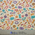 Dogs Accessories Collars Scrub Cap from Medicus Scrub Caps, featuring a playful pattern of dog toys, bones, bowls, and paw prints on a light background.