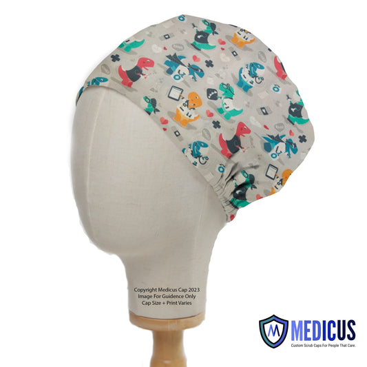 Dr Dinosaurs Scrub Cap from Medicus Scrub Caps, featuring a fun dinosaur-themed medical pattern on a beige background.