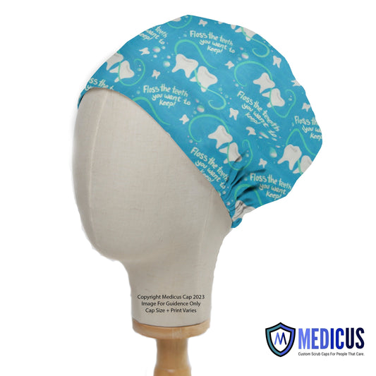 On a mannequin head, the Floss The Teeth You Want To Keep dentist scrub cap by Medicus Scrub Caps features a dental-themed design with teeth and floss symbols.