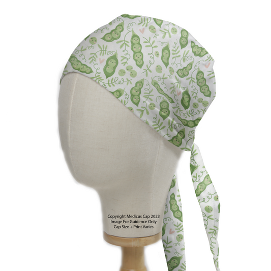 Food Peas In Pod Scrub Cap from Medicus Scrub Caps, featuring a playful green pea pod pattern on a white background.