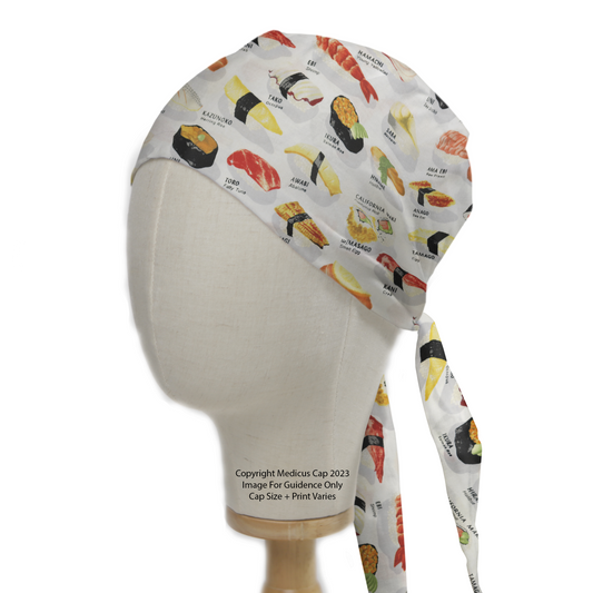 A mannequin head displays the Food Sushi Menu Scrub Cap by Medicus Scrub Caps, featuring colorful sushi illustrations and a tie-back design for healthcare professionals.