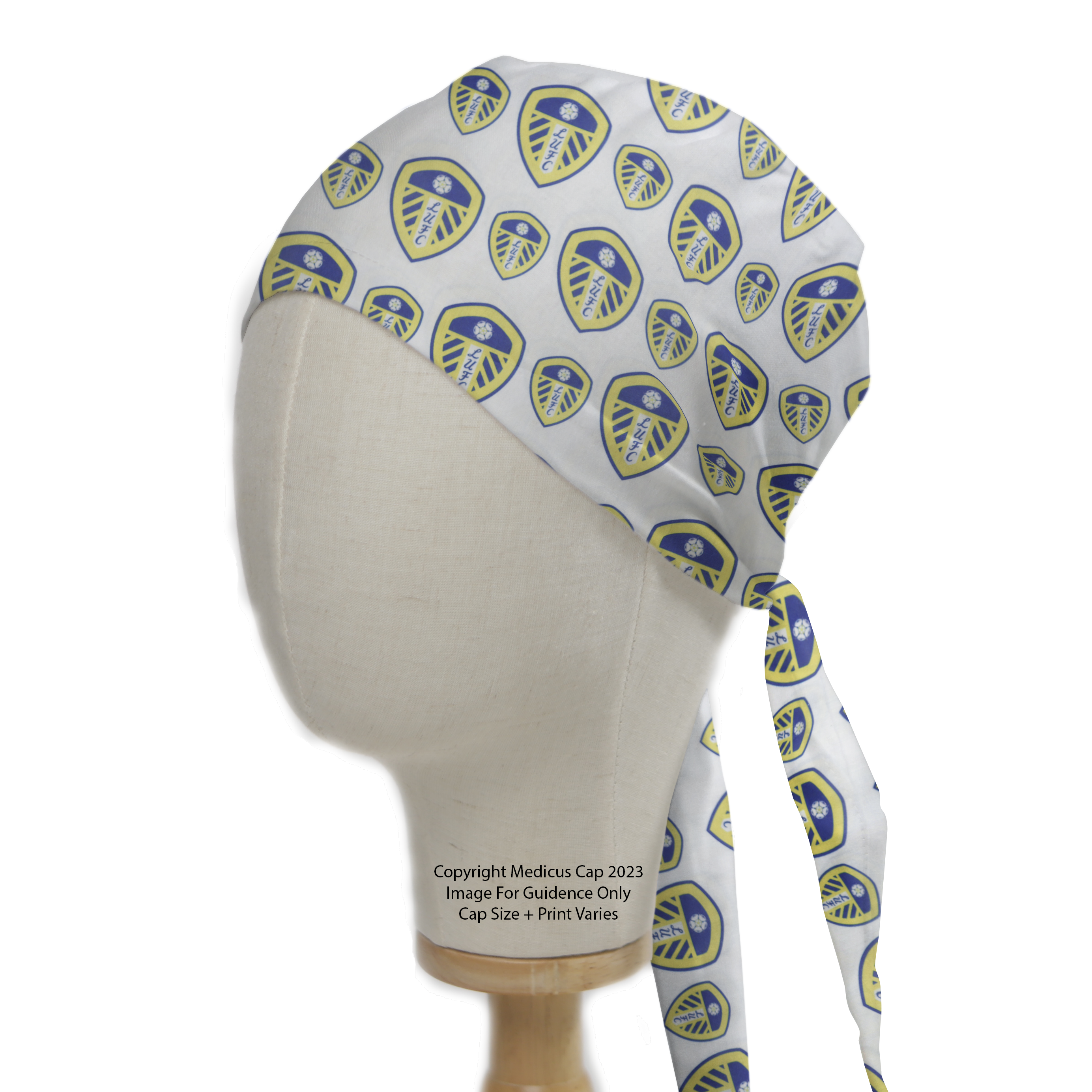 The Football Club Leeds United Scrub Cap by Medicus Scrub Caps features a blue and yellow club shield pattern on white, eco-friendly with long ties for medical professionals.