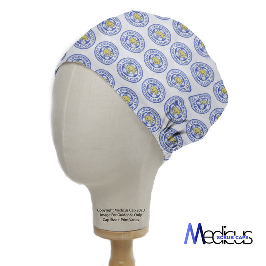 Football Club Leicester Scrub Cap by Medicus Scrub Caps, featuring a blue and yellow emblem pattern. Displayed on a mannequin head with logo in the bottom right.