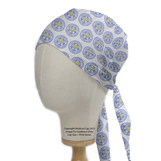 The Medicus Scrub Caps Football Club Leicester Scrub Cap, displayed on a mannequin, features a blue and yellow circular pattern. Stylish, reusable, and tie-back for comfort.