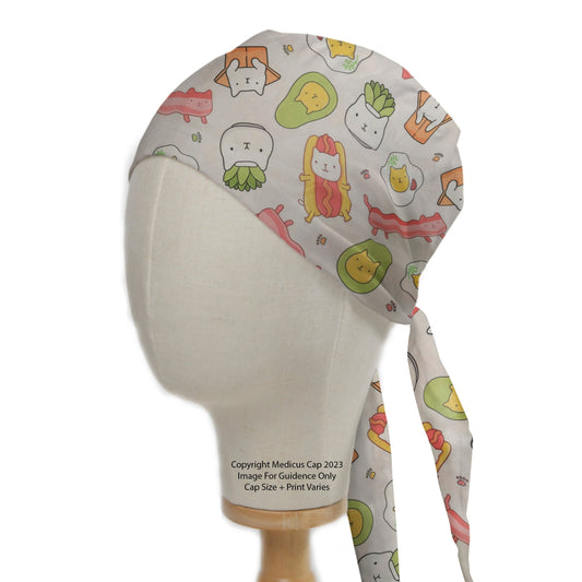 A mannequin head showcases a Medicus Scrub Cap with a fun pattern of cartoon cats as food, including sushi and avocados. Ties at the back.