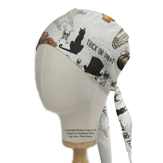 A mannequin head wears a Medicus Scrub Caps Halloween Trick or Treat Large Scrub Cap, featuring skulls, bats, pumpkins, and black cats for a festive touch.