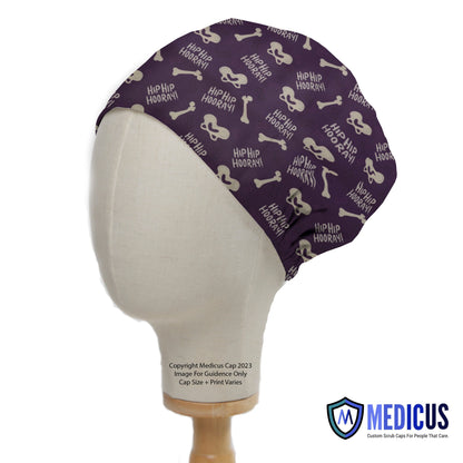 Hip Hip Hooray Scrub Cap from Medicus Scrub Caps, featuring a purple design with bones and hip joints. Custom scrub cap for medical professionals.