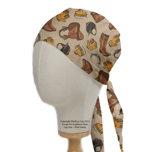 Horse Accessories Equestrian Scrub Cap from Medicus Scrub Caps, featuring a beige background with illustrated saddles, boots, gloves, and horse care items.