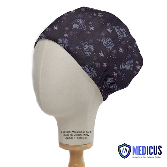 Ortho Surgery Scrub Cap from Medicus Scrub Caps, featuring a dark patterned design with text and floral accents.