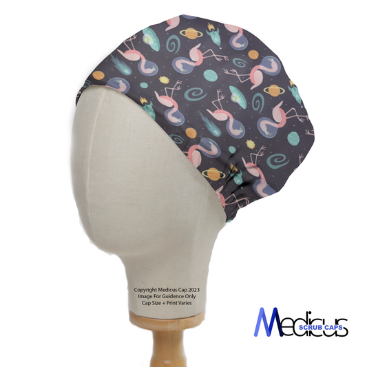 Space Flamingoes Travel Scrub Cap from Medicus Scrub Caps, featuring a dark background with floating pink flamingoes, planets, and stars.