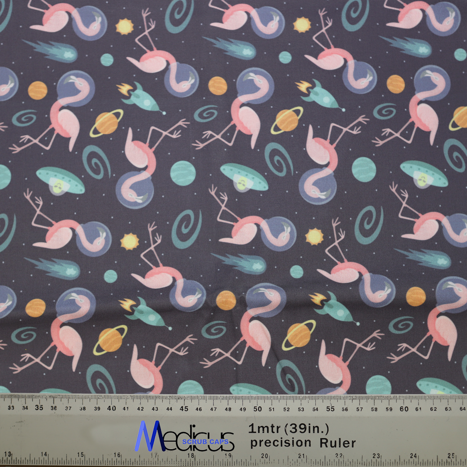 Space Flamingoes Travel Scrub Cap from Medicus Scrub Caps, featuring pink flamingoes in space with planets, rockets, and UFOs on a dark background.