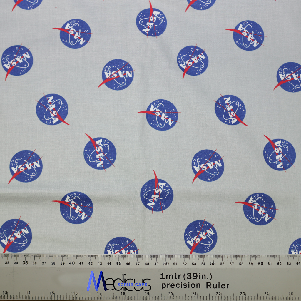 The Space NASA Logos Circles Scrub Cap by Medicus Scrub Caps features a fabric design with NASA logos, blue circles, red vectors, and a measurement ruler.
