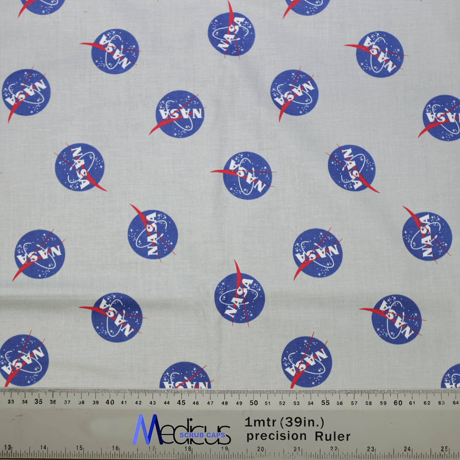 The Space NASA Logos Circles Scrub Cap by Medicus Scrub Caps features a fabric design with NASA logos, blue circles, red vectors, and a measurement ruler.