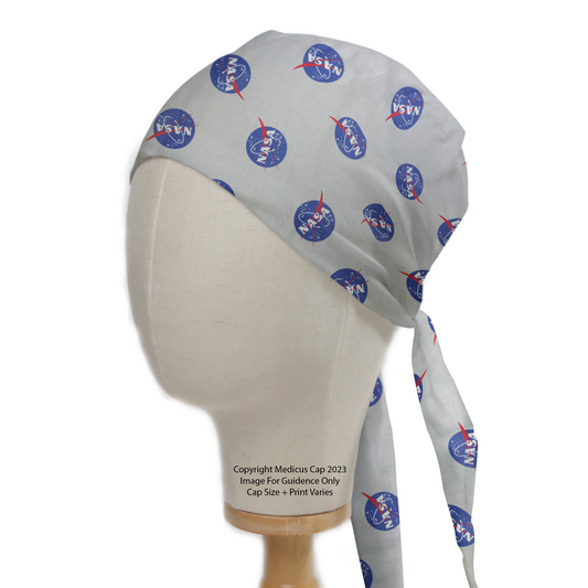 The Space NASA Logos Circles Scrub Cap by Medicus Scrub Caps features a gray design with NASA logos, displayed on a mannequin with an extended tail for style.