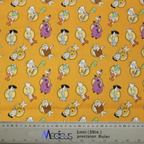 An orange Medicus Scrub Cap features Flintstones characters, cavemen, and dinosaurs, with a ruler ensuring precise fit for this fun, nostalgic design.