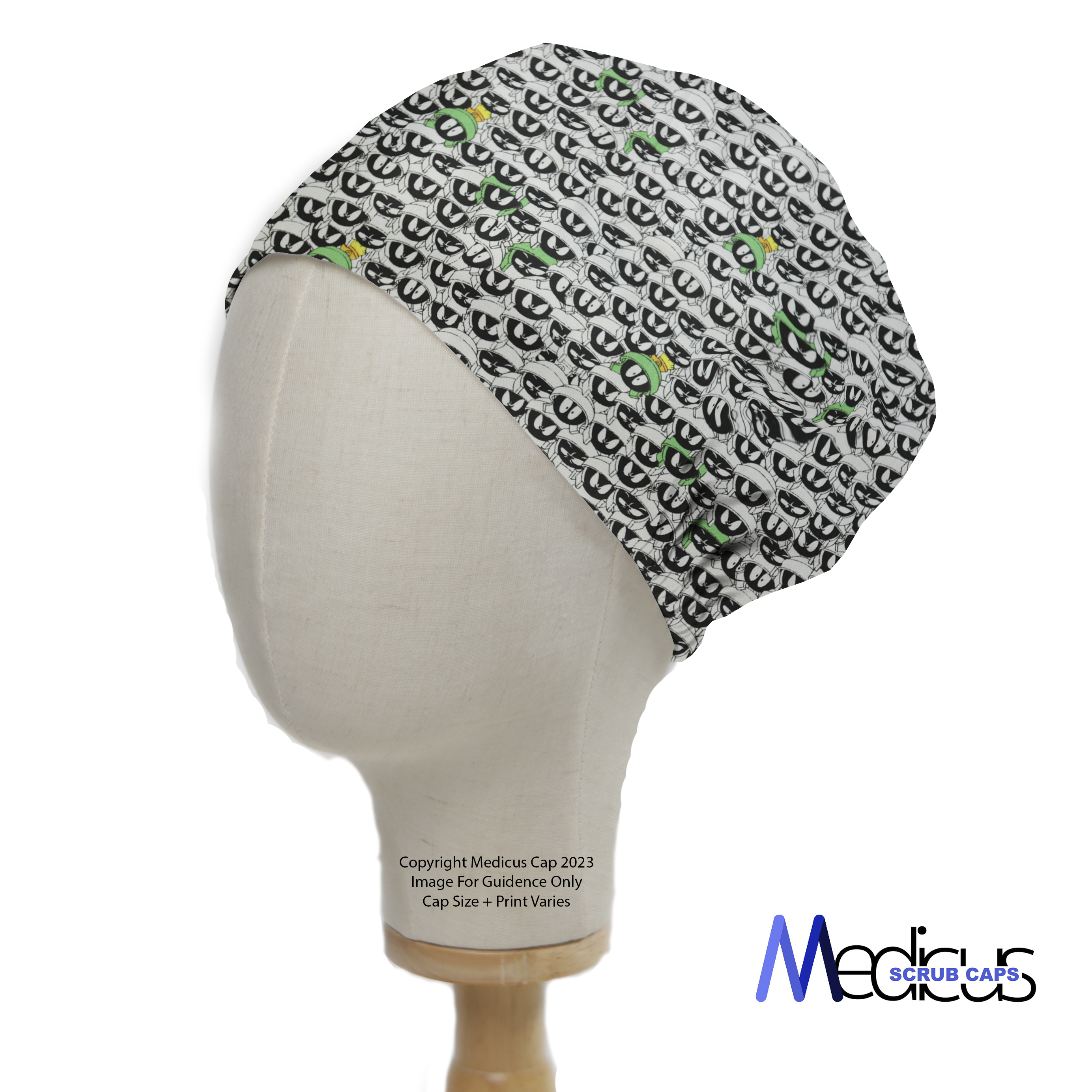A mannequin displays a Medicus Scrub Caps product: the TV Cartoon Looney Tunes Marvin Martian Crowd Scrub Cap, featuring a monochrome design with green and yellow accents.