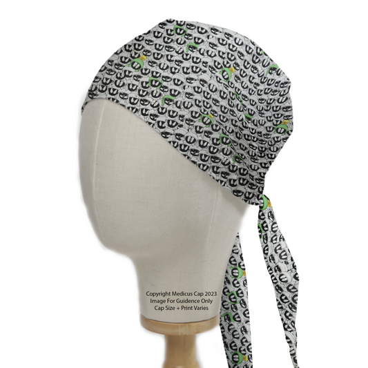 A mannequin head displays the Medicus Scrub Caps TV Cartoon Looney Tunes Marvin Martian Crowd Scrub Cap, featuring a patterned design with green accents and tie-back closure.