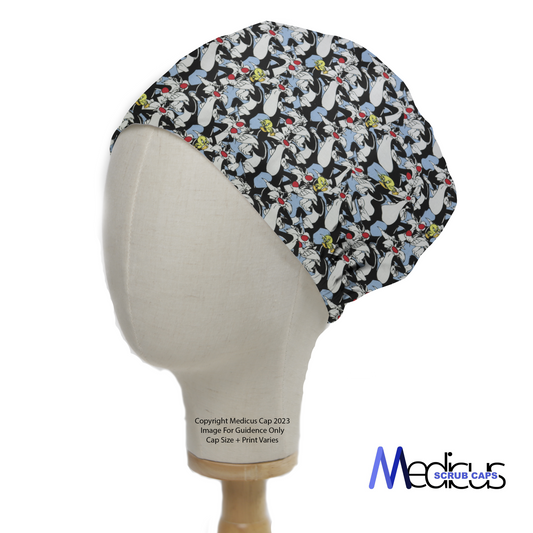 Side view of a mannequin head wearing a Medicus Scrub Cap featuring a playful Looney Tunes Sylvester and Tweety Bird pattern in black, white, and colorful accents.