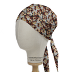 Medicus Scrub Caps TV Cartoon Looney Tunes Tasmanian Devil Scrub Cap on a mannequin head, featuring a lively brown, red, and beige cartoon pattern with tie strings.