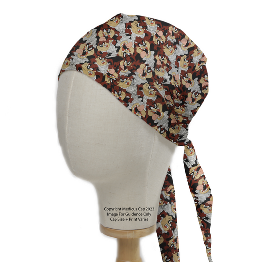 Medicus Scrub Caps TV Cartoon Looney Tunes Tasmanian Devil Scrub Cap on a mannequin head, featuring a lively brown, red, and beige cartoon pattern with tie strings.