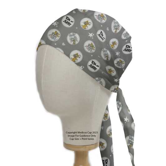 Tom And Jerry Circles Grey Scrub Cap from Medicus Scrub Caps, featuring a playful pattern on a grey background, displayed on a mannequin head.