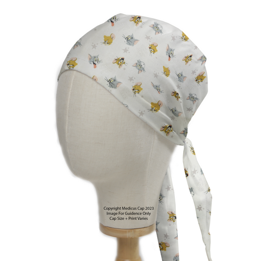 Tom And Jerry Heads Toss Scrub Cap from Medicus Scrub Caps, featuring a playful pattern of Tom and Jerry faces on a light background.