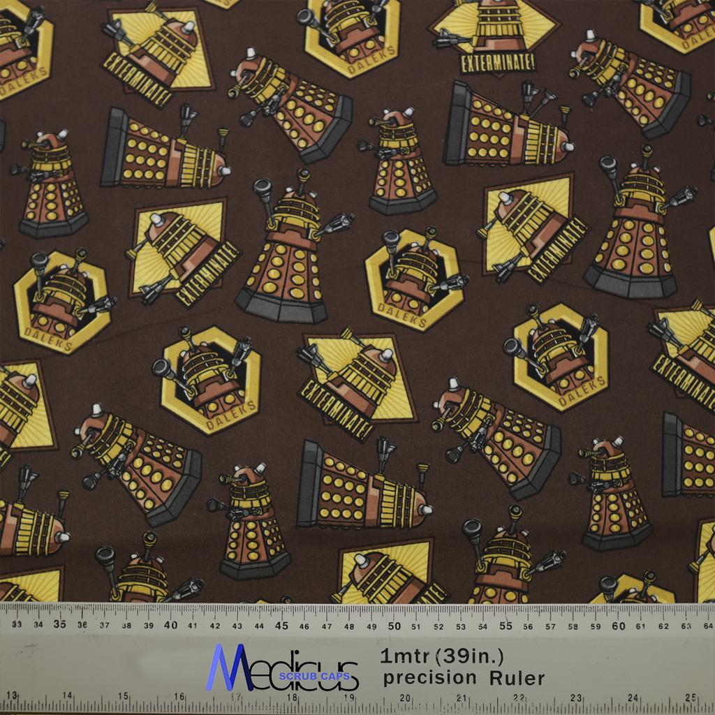 The Dr Who Dalek Brown Scrub Cap by Medicus Scrub Caps features Dalek designs on a brown background with hexagonal motifs. Includes a 1m (39in) ruler.