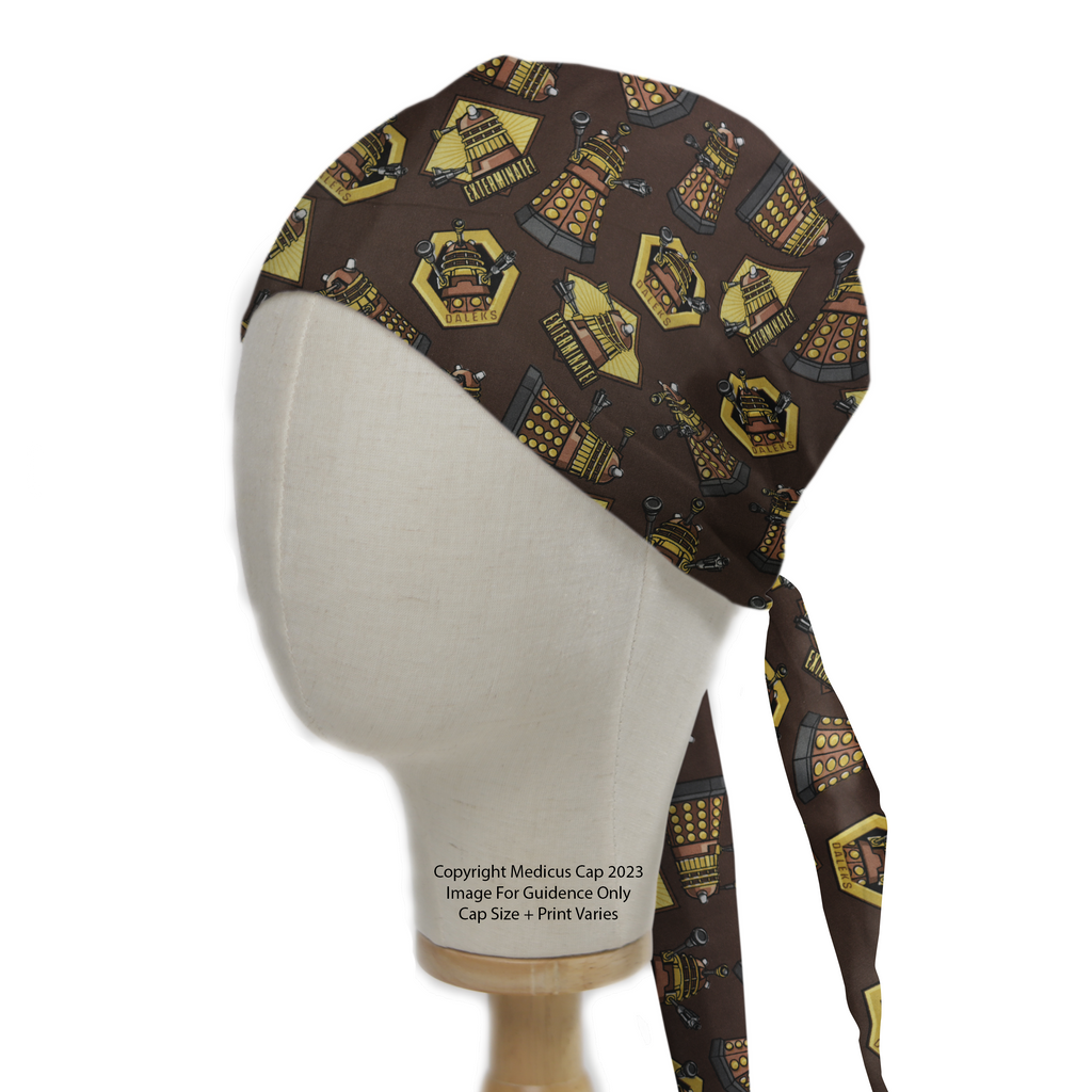 A mannequin head wears a Medicus Scrub Caps Dr Who Dalek Brown scrub cap, featuring golden Daleks on a brown background with tied straps on the side.