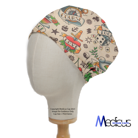 Tattoos #2 Luck Love Scrub Cap from Medicus Scrub Caps, featuring vintage tattoo-inspired designs with hearts, dice, anchors, and banners on a beige background.