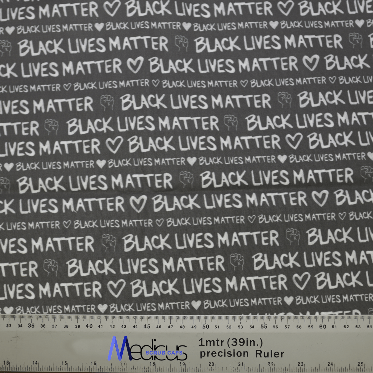 The Black Lives Matter BLM Scrub Cap by Medicus Scrub Caps is a black fabric with Black Lives Matter and white-printed hearts. It includes a one-meter precision ruler at the bottom featuring the Moore SpaceSolutions logo.