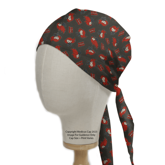 A mannequin head displays the Black Widow Red Kawaii Superhero Scrub Cap by Medicus Scrub Caps in dark gray with red and white cartoon faces, featuring Super Mom in bold red. This playful yet practical superhero-style cap ties neatly at the back.