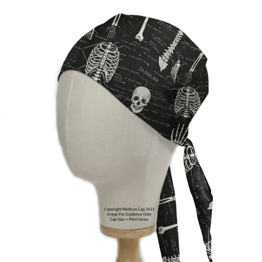 A mannequin head displays the eco-friendly Glow In The Dark Bones Anatomy Scrub Cap by Medicus Scrub Caps, featuring adjustable ties and a black design with white skeletal patterns like skulls and vertebrae.