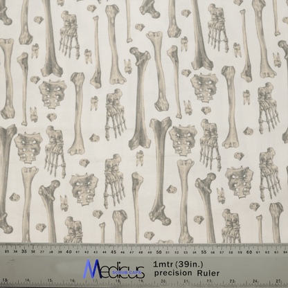 The Bones Scrub Cap by Medicus Scrub Caps displays bone illustrations, like skulls, pelvises, and hands, on a light background—ideal for healthcare settings. A ruler at the bottom shows both centimeter and inch measurements, highlighting precision and sustainability.