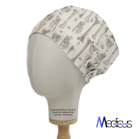 The mannequin head is wearing a Bones Scrub Cap by Medicus Scrub Caps, featuring a pattern of skulls and femurs on a light background, with the brands logo prominently displayed in the lower right to emphasize their commitment to sustainability.