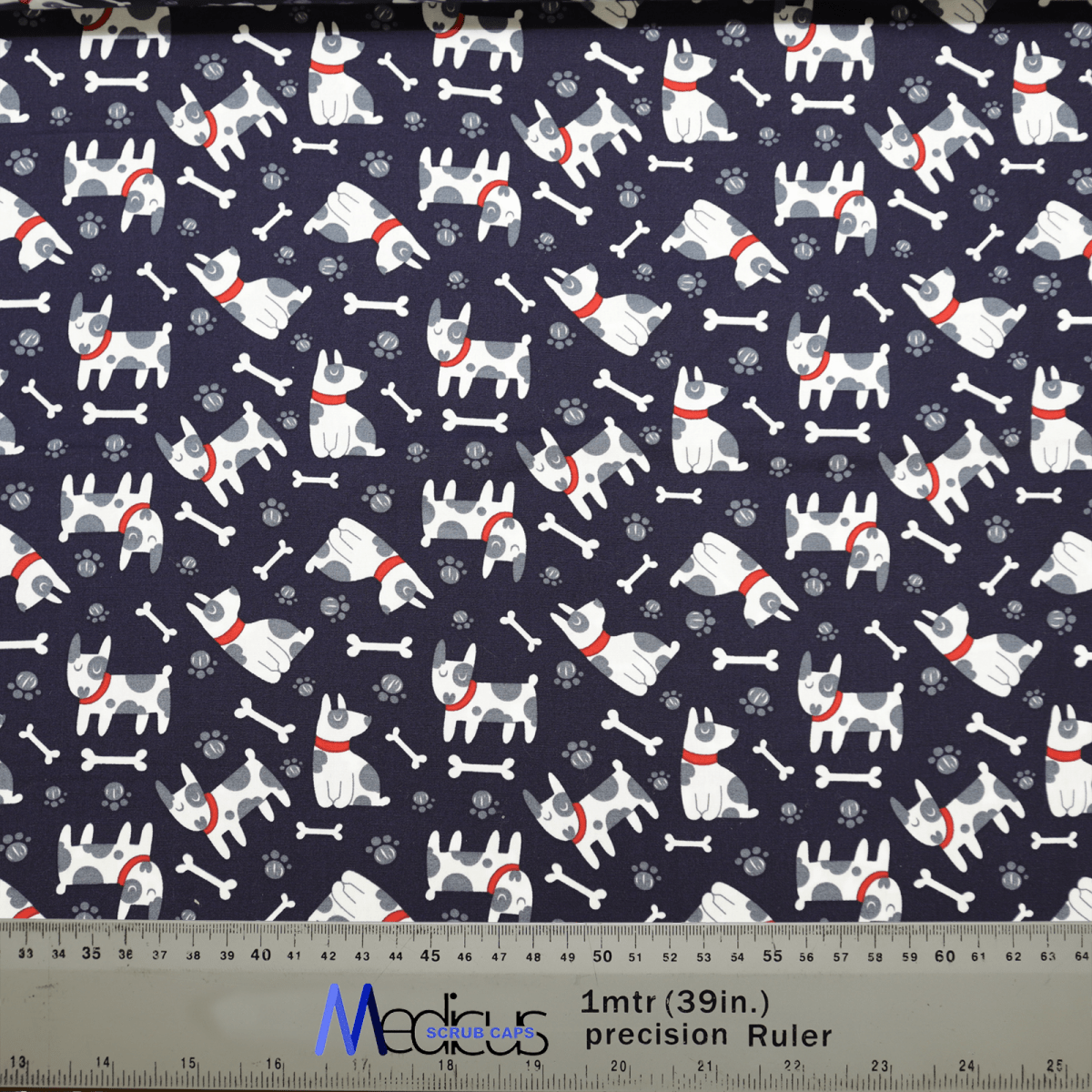Patterned fabric with Boston Terrier dogs and bones on a dark background features white pups in red collars, ideal for custom embroidery. Includes a ruler in meters and inches. Perfect for crafting a unique Boston Terrier Dogs Scrub Cap from Medicus Scrub Caps.